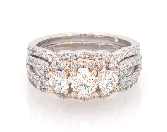 Previously Owned THE LEO Round-Cut Diamond Three-Stone Halo Bridal Set 1-7/8 ct tw 14K Two-Tone Gold Size 6.5